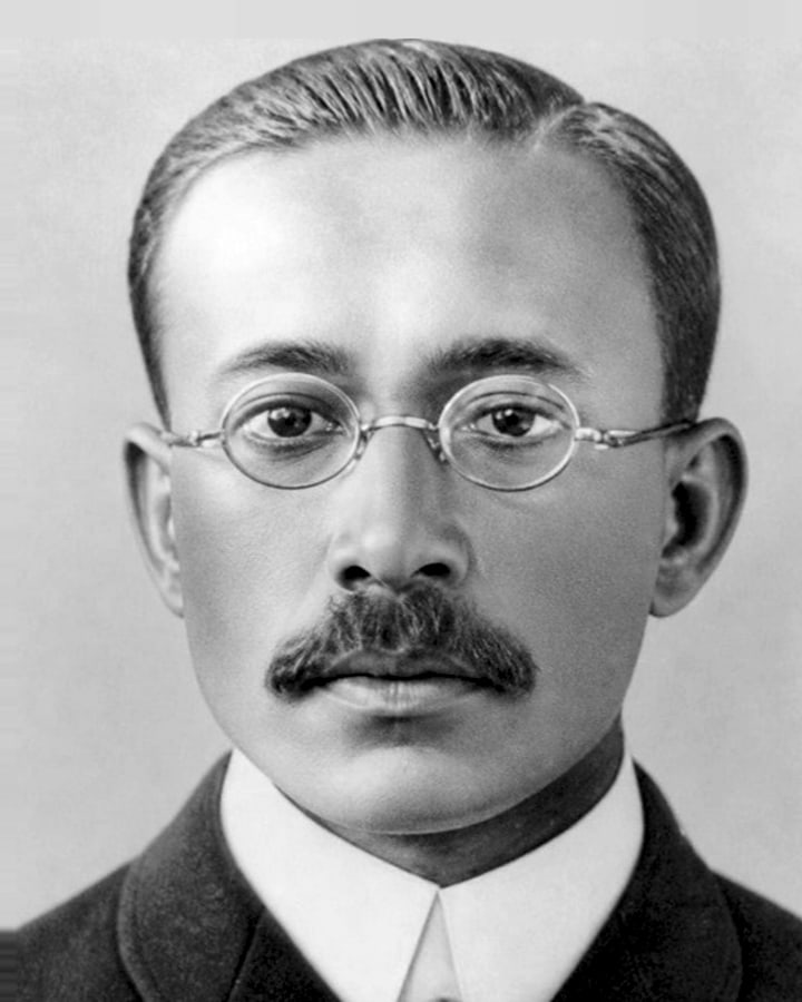 Archive portrait of the late Mr. Harjivandas Nemidas in a dark suit and round spectacles